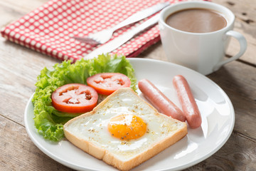 Breakfast, Egg in a hole with sausage and coffee.