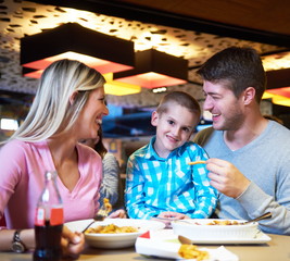 family having lunch in shopping mall