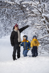 three happy boys in forest