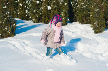 Fototapeta na wymiar Little girl running in the snow in winter, lifestyle, winter holidays