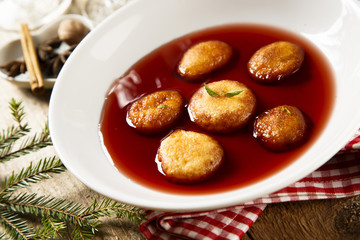 Sweet fried donuts in wine sauce