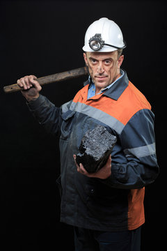 coalminer holds out a large chunk of energy rich coal 