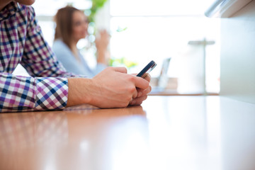 Male hands using smartphone