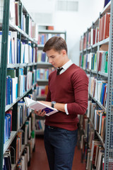Man reading book in university library