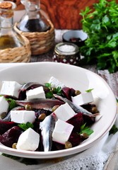 Fototapeta na wymiar beet salad with goat cheese, anchovies, capers, parsley and olive oil