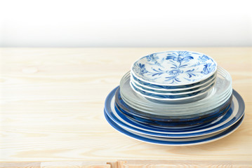 Blue and white dishes, plates and bowls on the cupboard at home