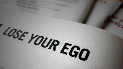 Lose your ego word on a book - obrazy, fototapety, plakaty