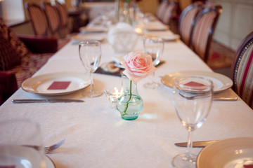 interior of the restaurant,  large table laid for  Banquet