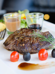 Delicious beef steaks on white plate