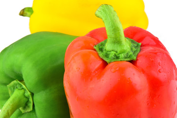 colored peppers over white background