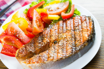 Grilled salmon steak with fresh vegetables