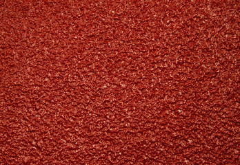 Dark red rough, porous,surface.Horizontal.