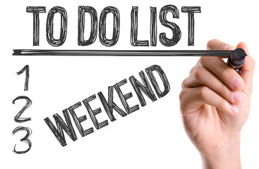 Hand with marker writing: To Do List: Weekend 