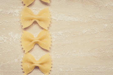 Farfalle pasta on the wooden background