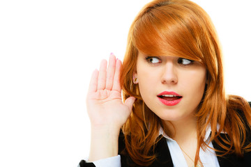 woman with hand to ear listening