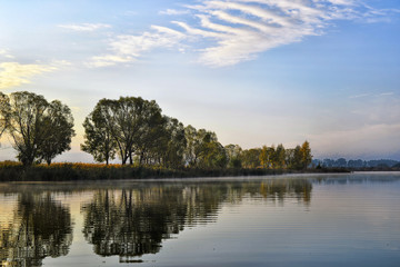 Fototapeta na wymiar Water landscape with clouds reflection