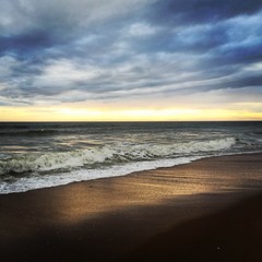 Fototapeta na wymiar heavy cloud cant hide sunset over the Atlantic coast