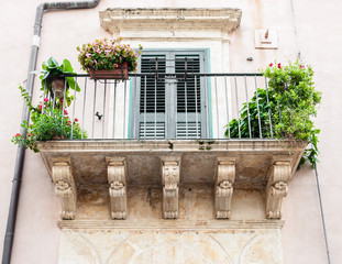 Fototapeta na wymiar Balcony with baroque decorations in a house of Noto (Sicily)