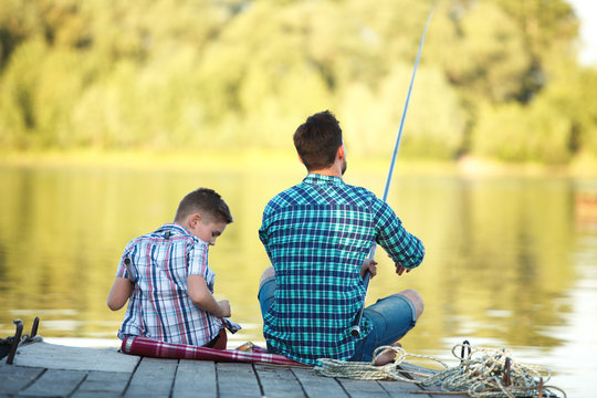 Man And Boy Fishing On The Lake