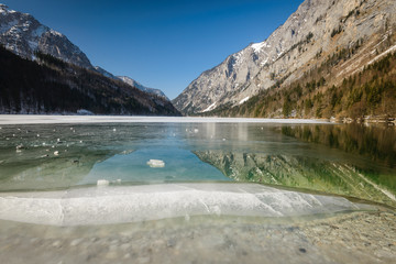 Winter landscape with frozen lake and mountains in background.Leopoldsteinersee,Styria,Austria.