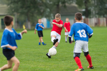 Obraz na płótnie Canvas boy kicking football