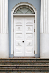 White wooden door with an arch.