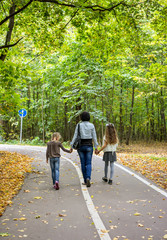 Fototapeta premium Family walking in autumn park