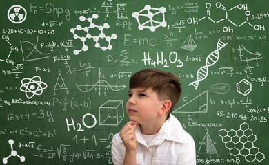 Thinking little boy with math formula