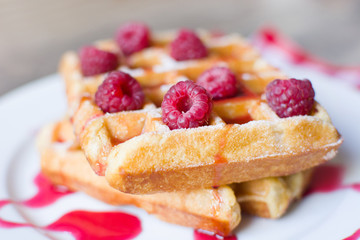 Waffles with raspberries and strawberry syrup