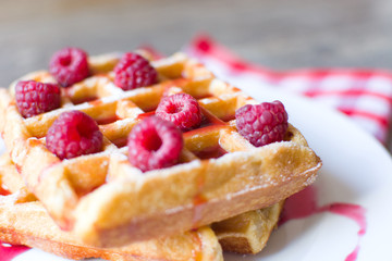 Waffles with raspberries and strawberry syrup