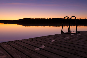 Night swim dock and calm lake at twilight - Powered by Adobe