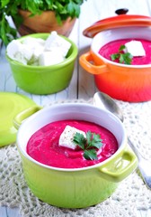 Cream soup from beet with goat's cheese and olive oil. Healthy food.