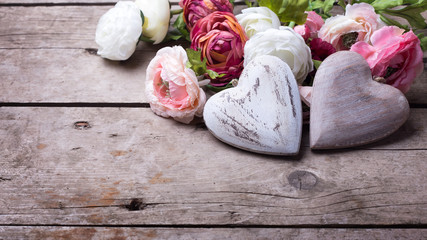 Two decorative white wooden  hearts and flowers