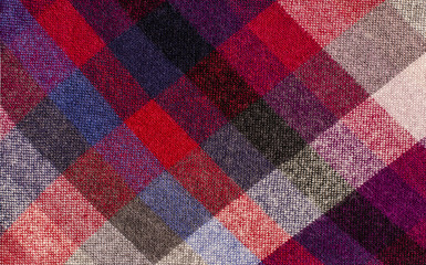 Scottish tartan pattern. Red plaid print as background. Colored lines and square pattern. Scottish checked fabric.