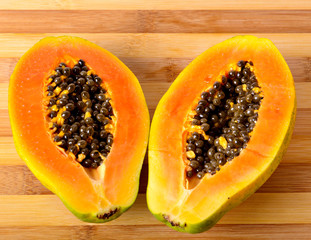 Sliced fresh papaya on wooden background