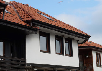 The second floor of the house with a tiled roof