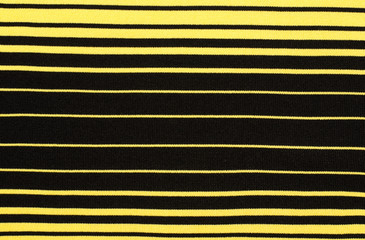 Striped black and yellow textile pattern as a background. Close up on horizontal stripes material...