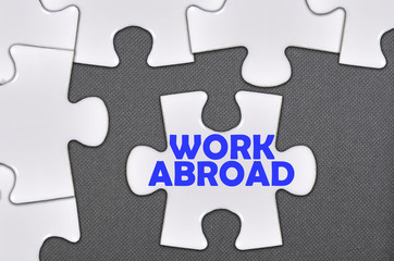 Fototapeta premium jigsaw puzzle written word work abroad
