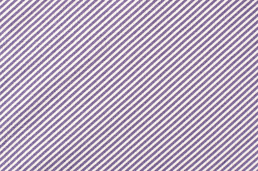 Striped purple and white textile pattern as a background. Close up on diagonal stripes material texture fabric.