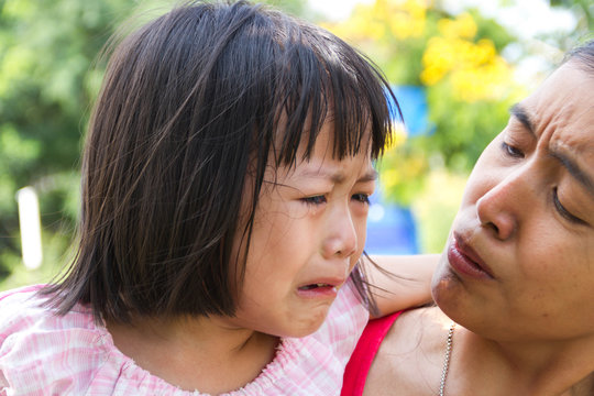 Little asian girl crying with her mom