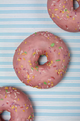 pink donut on blue striped background