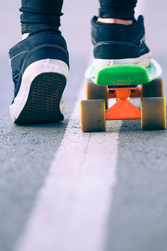 Close view of legs and skateboard 