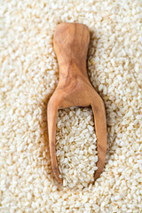 sesame seeds in a wooden scoop