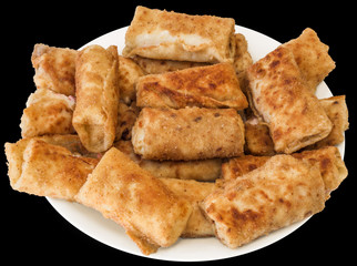 Plateful of freshly fried Cheese and Ham Breaded Pancake Rolls, Isolated on black background.