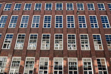 Fototapeta na wymiar Brick facade with large windows