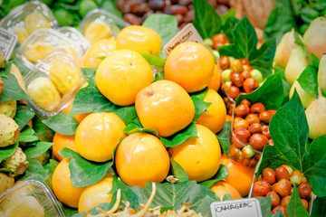 Stack ordered persimmon exhibited by a greengrocer
