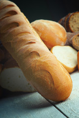 Baguette and fresh bread on a table