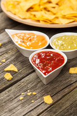 Plate of nachos with different dips