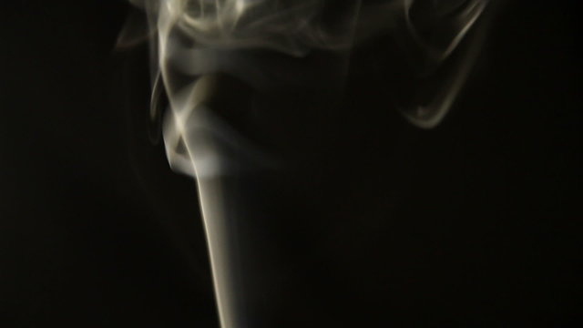 Smoke flowing in the air on a black background.