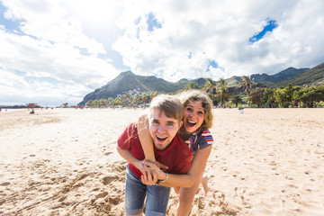 Happy couple running on the beach. 